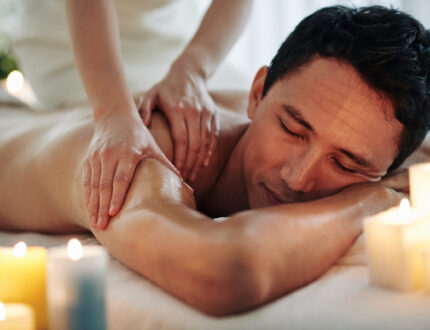 Handsome middle-aged man enjoying relaxing spa massage with oils